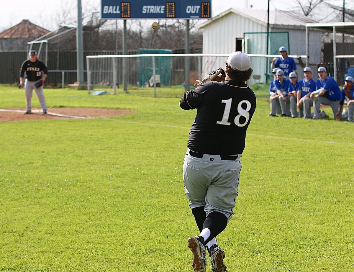 Image: Gladiator third-baseman John Byers(18) tosses the ball to teammate Tyler Vencill(18) at first-base during pregame warm ups, with the Polar Bears peering from the sideline.