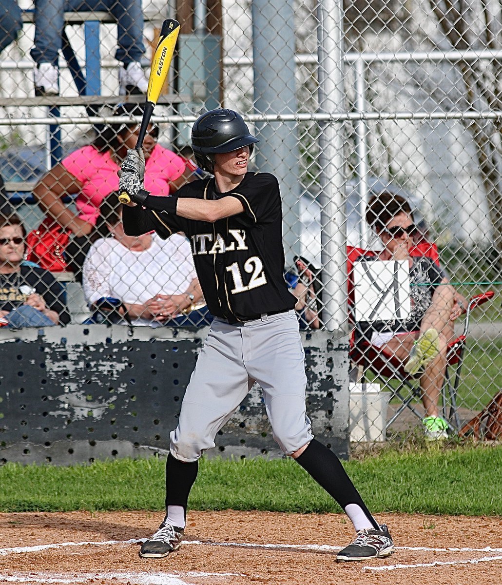 Image: Gladiator Ty Windham(12) awaits the pitch as mom, Andi Windham, bites her nails.