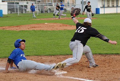 Image: Gladiator senior Tyler Vencill(15) tries to catch the ball in time to stop a Frost runner from sliding safely across the first-base bag.