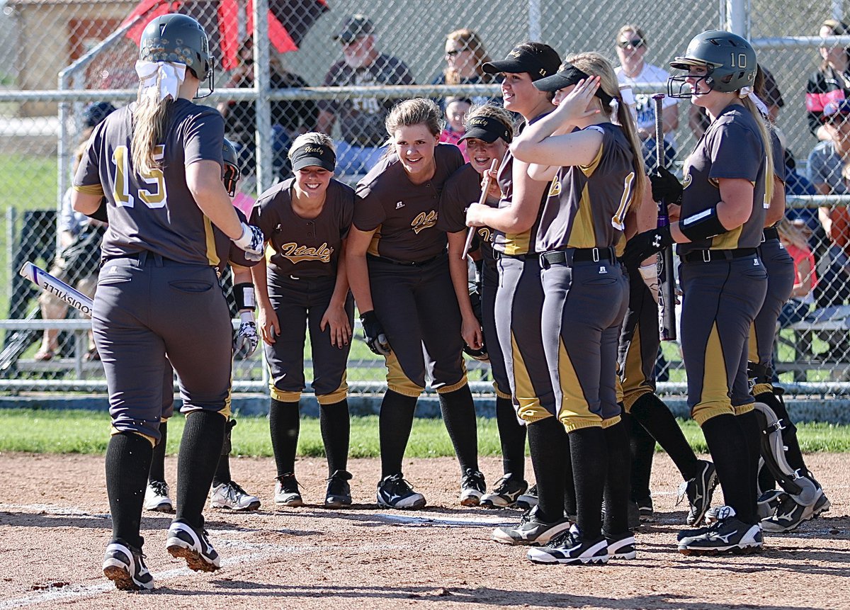 Image: Senior Jaclynn Lewis(15) is greeted at home plate by her Lady Gladiator teammates after hitting her first of two over-the-fence homeruns against Frost. Italy would go on to win their district opener 17-6.
