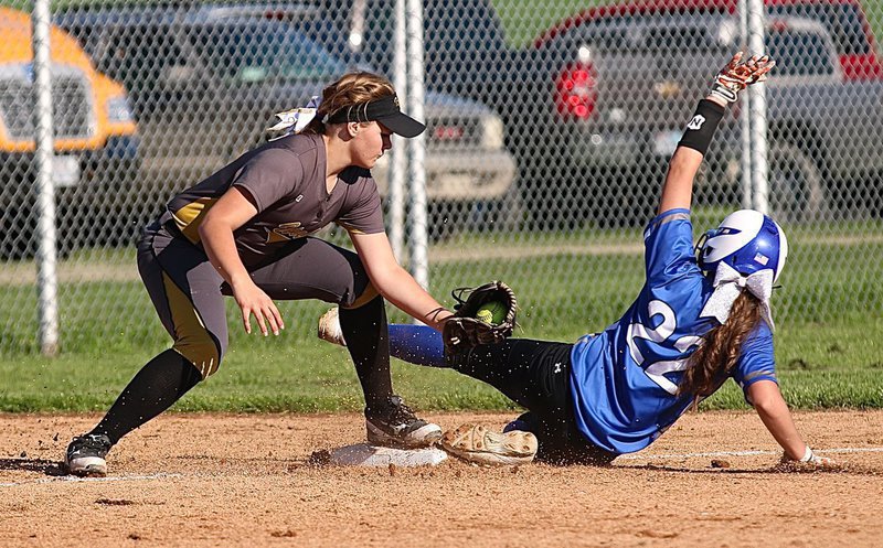 Image: A Frost runner just makes it before the tag by Lady Gladiator third-baseman Lillie Perry(9).