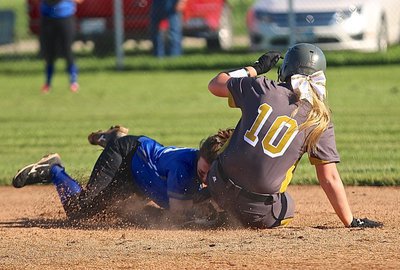 Image: Crunch! Madison Washington(10) and her powerful slide forces the ball out of the mitt of the Frost shortstop for a double.