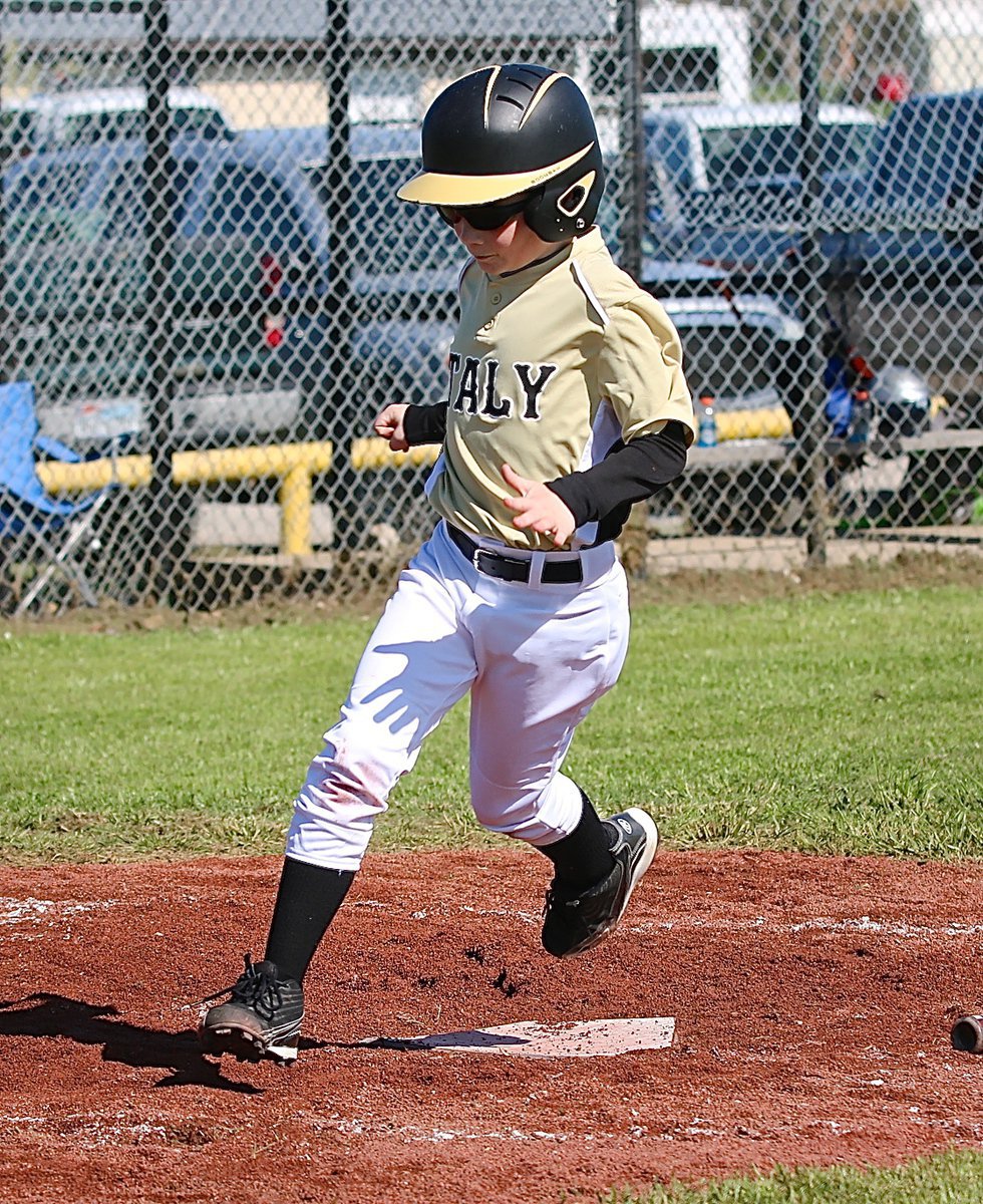 Image: Clayton Hellner hurries across home plate for an Italy run.