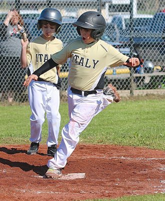 Image: Brodie Hugghins watches teammate Jay Copeland step on home plate for an Italy run against Kopperl.
