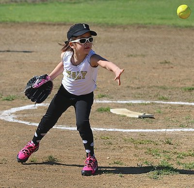 Image: Italy Girls T-ball pitcher Halee Carr tosses the ball to first base.