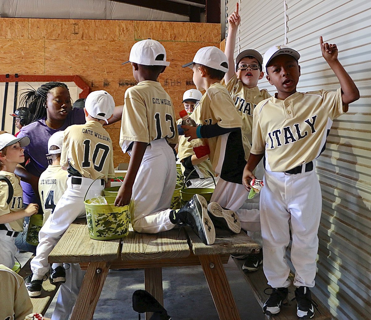 Image: Italy’s Lucky Johnson (Far right) and his teammates celebrate an 8-4 win over Maypearl in 8U the Boys Machine Pitch division before sharing Lucky’s birthday cake.