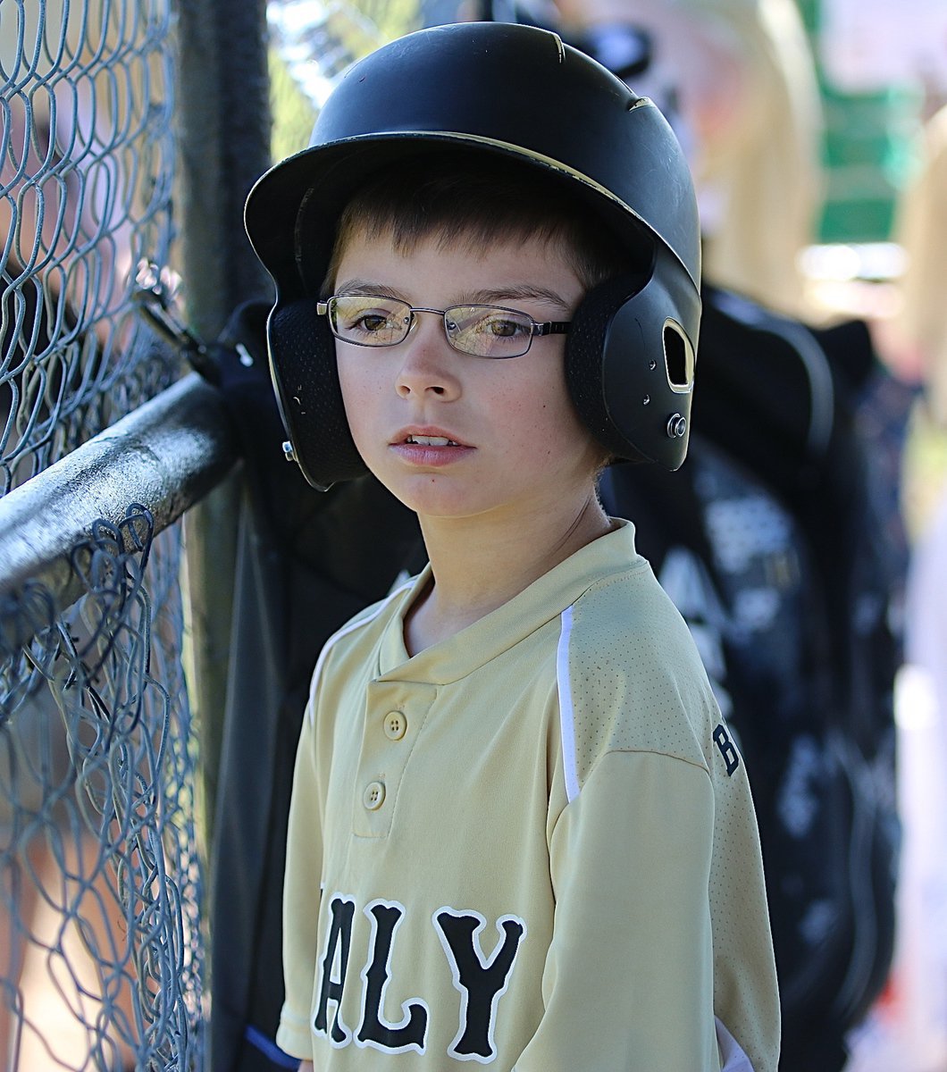 Image: Patiently waiting to bat in the dugout.