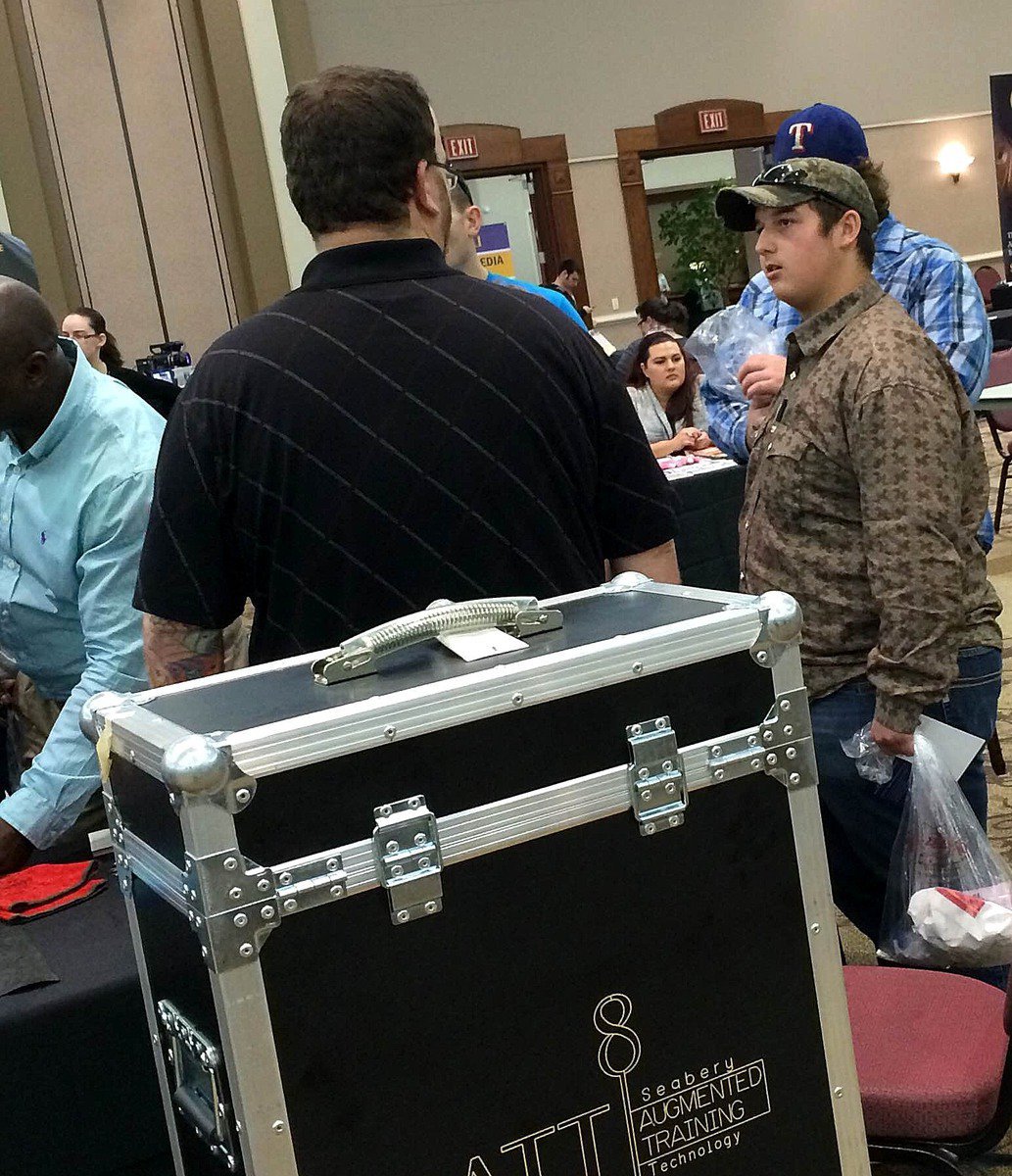 Image: Seniors Sam Corley, Nathan Kerbow and Coby Jeffords speaking with local college representatives.