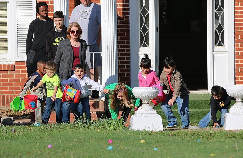 Image: And away they go! These excited Easter egg searchers take off across the front lawn of the S.M. Dunlap Memorial Library in Italy for the annual hunt.
