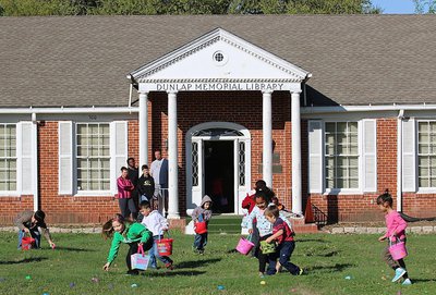 Image: The Dunlap Memorial Library serves as a historical backdrop during its annual Easter egg hunt on the front lawn.