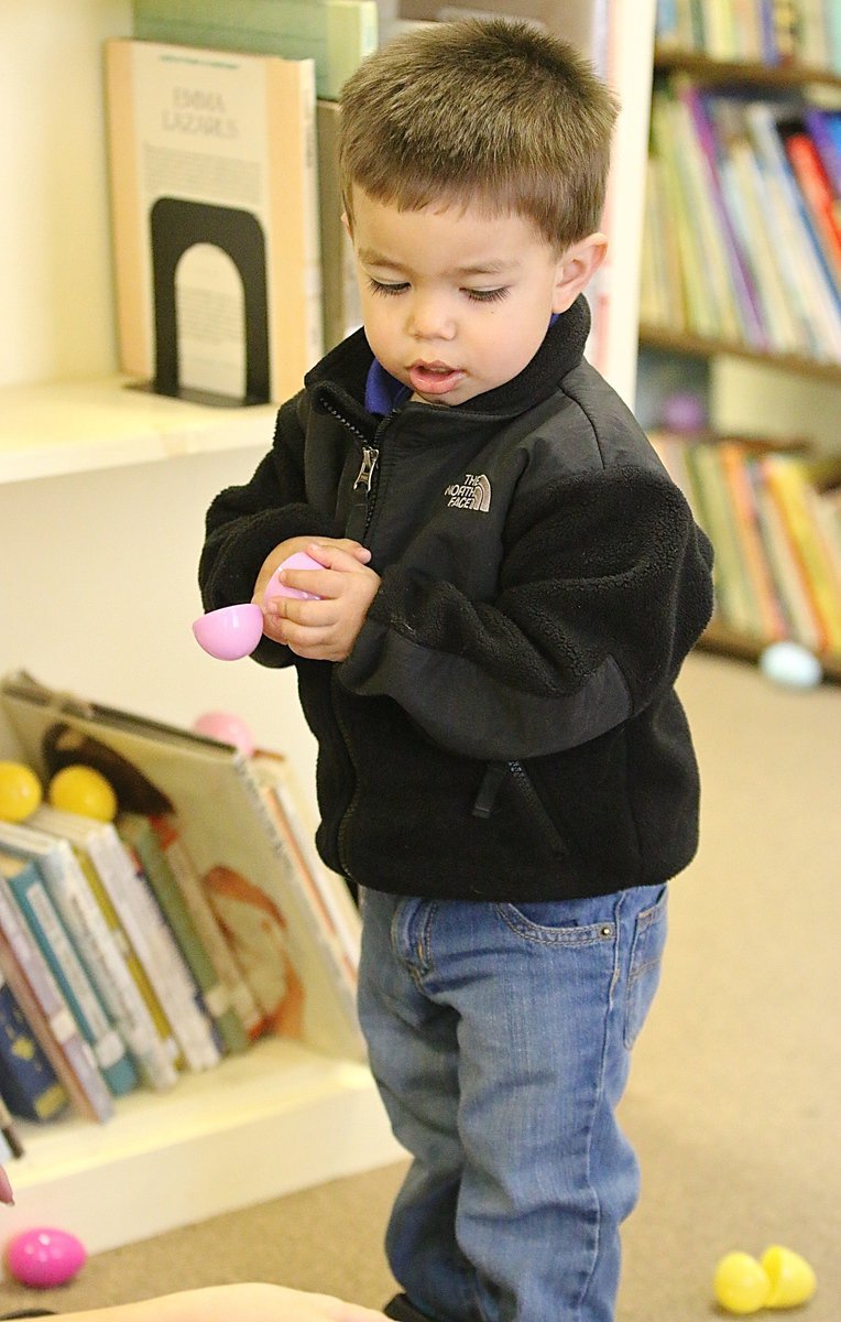 Image: Noah starts early and goes after the candy inside the eggs.