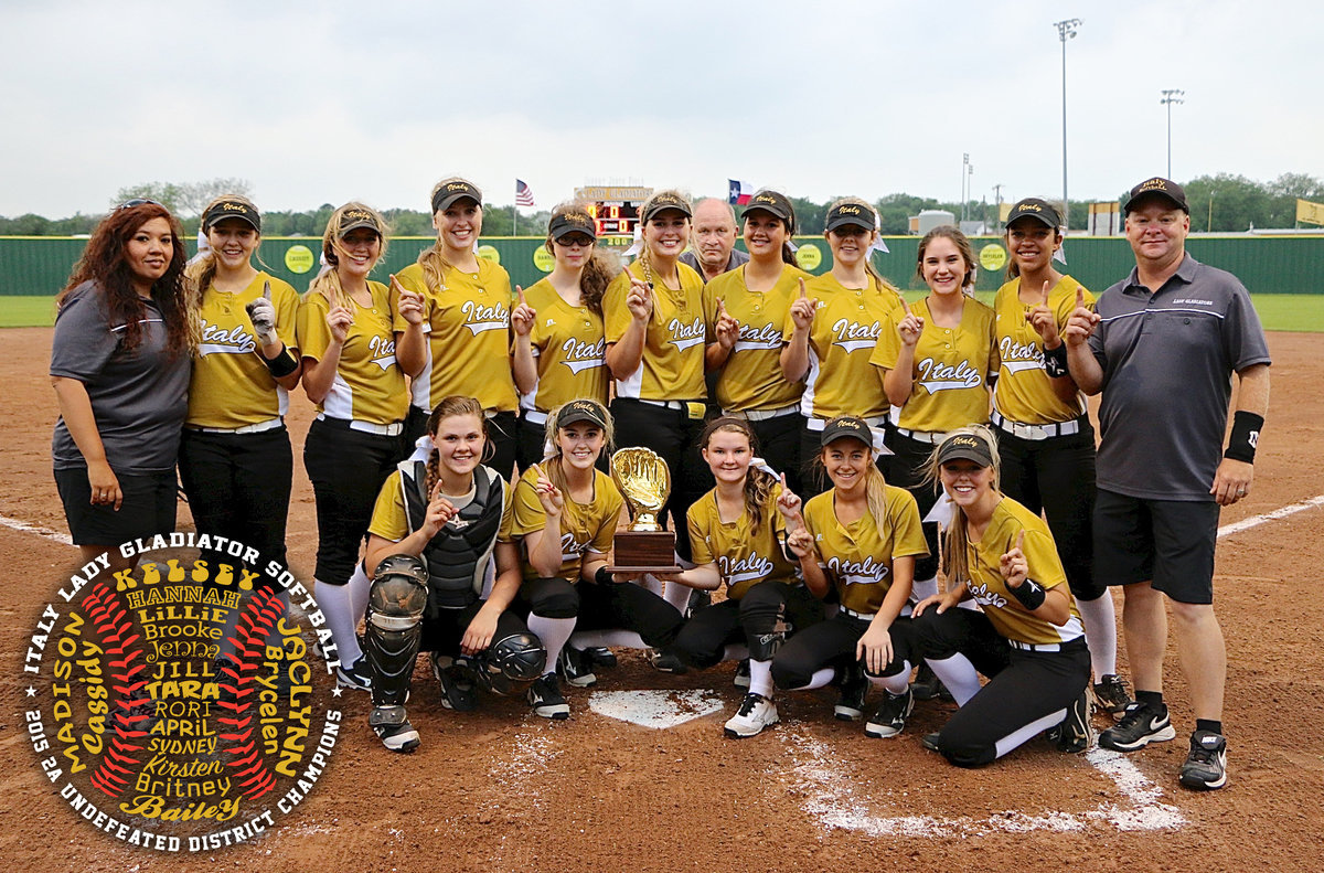Image: The Italy Lady Gladiators dominated as 2015 2A Undefeated District Champions to take plenty of momentum with them into the Playoffs. Pictured along the back row (L-R): Head Softball Coach Tina Richards, Brycelen Richards, Hannah Washington, Jaclynn Lewis, Rori Russell, Madison Washington, the head of Assistant Coach Johnny Jones, Jenna Holden, Brooke DeBorde, Cassidy Childers, April Lusk and Assistant Coach Michael Chambers. Front row (L-R): Lillie Perry, Kelsey Neslon, the District Championship Trophy, Tara Wallis, Britney Chambers and Bailey Eubank.