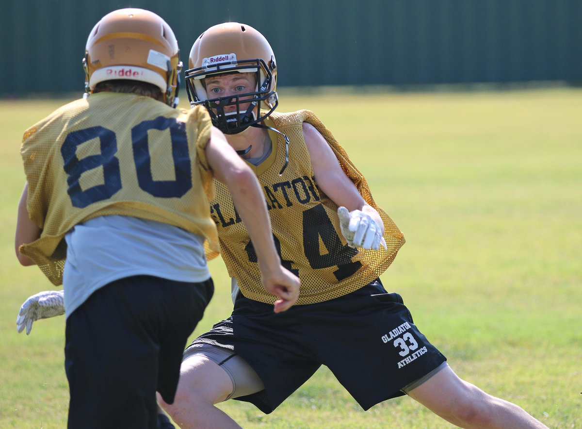 Image: Clayton Miller(34) closes in a on a receiver during team drills.