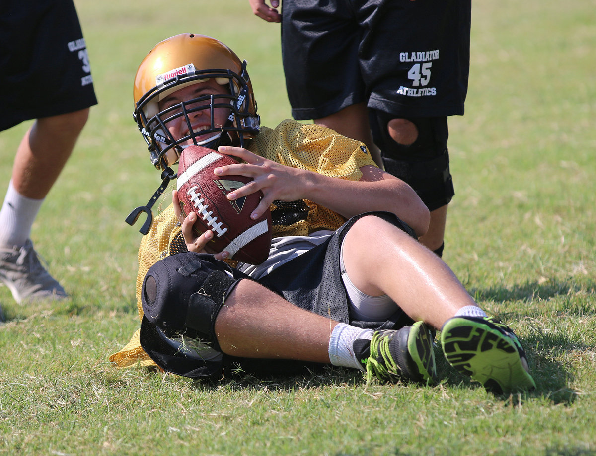 Image: Defensive lineman Austin Crawford(55) recovers a fumble during team drills.