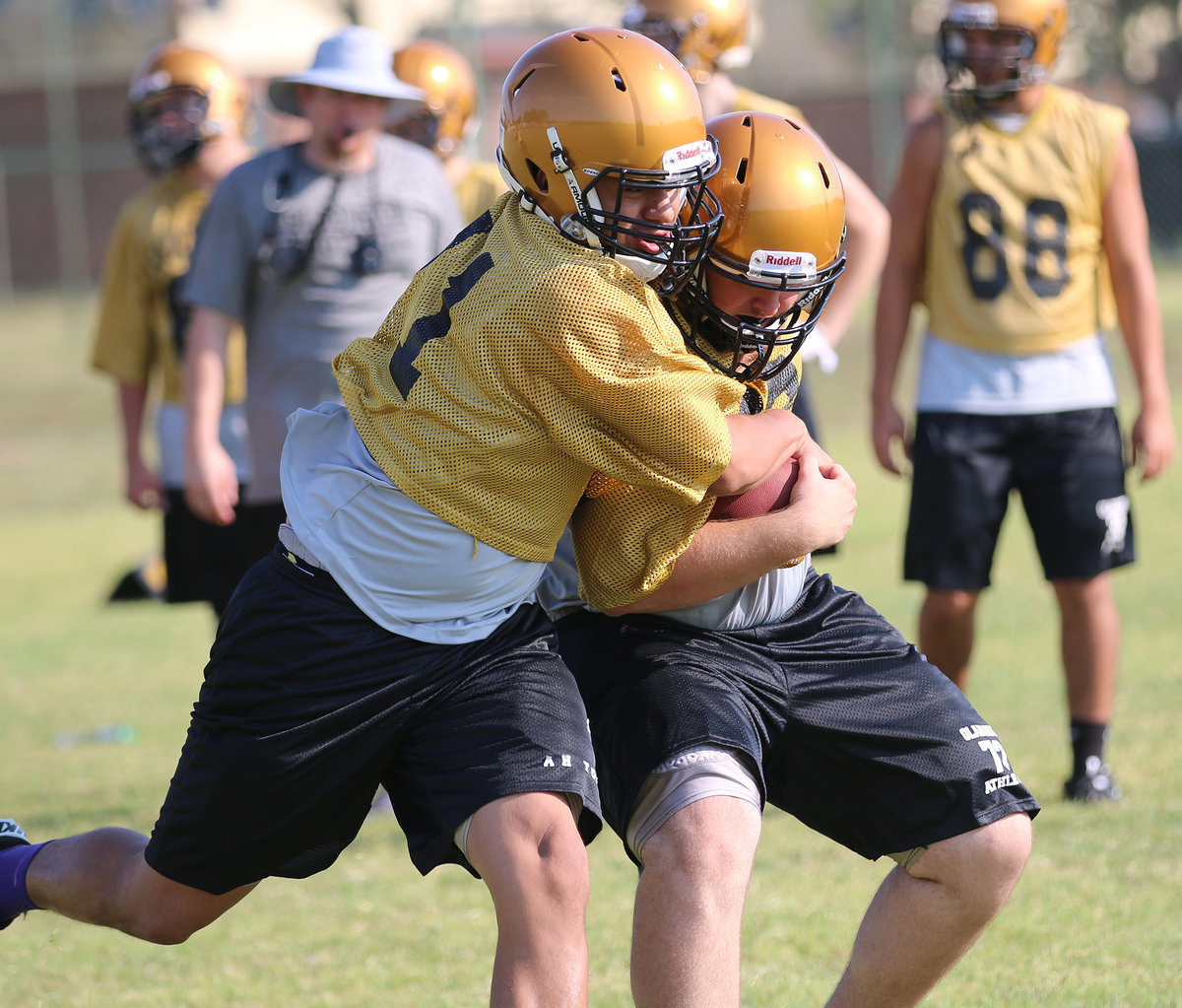 Image: David De La Hoya(71) tries to strip the ball away from teammate Aaron Pittmon.