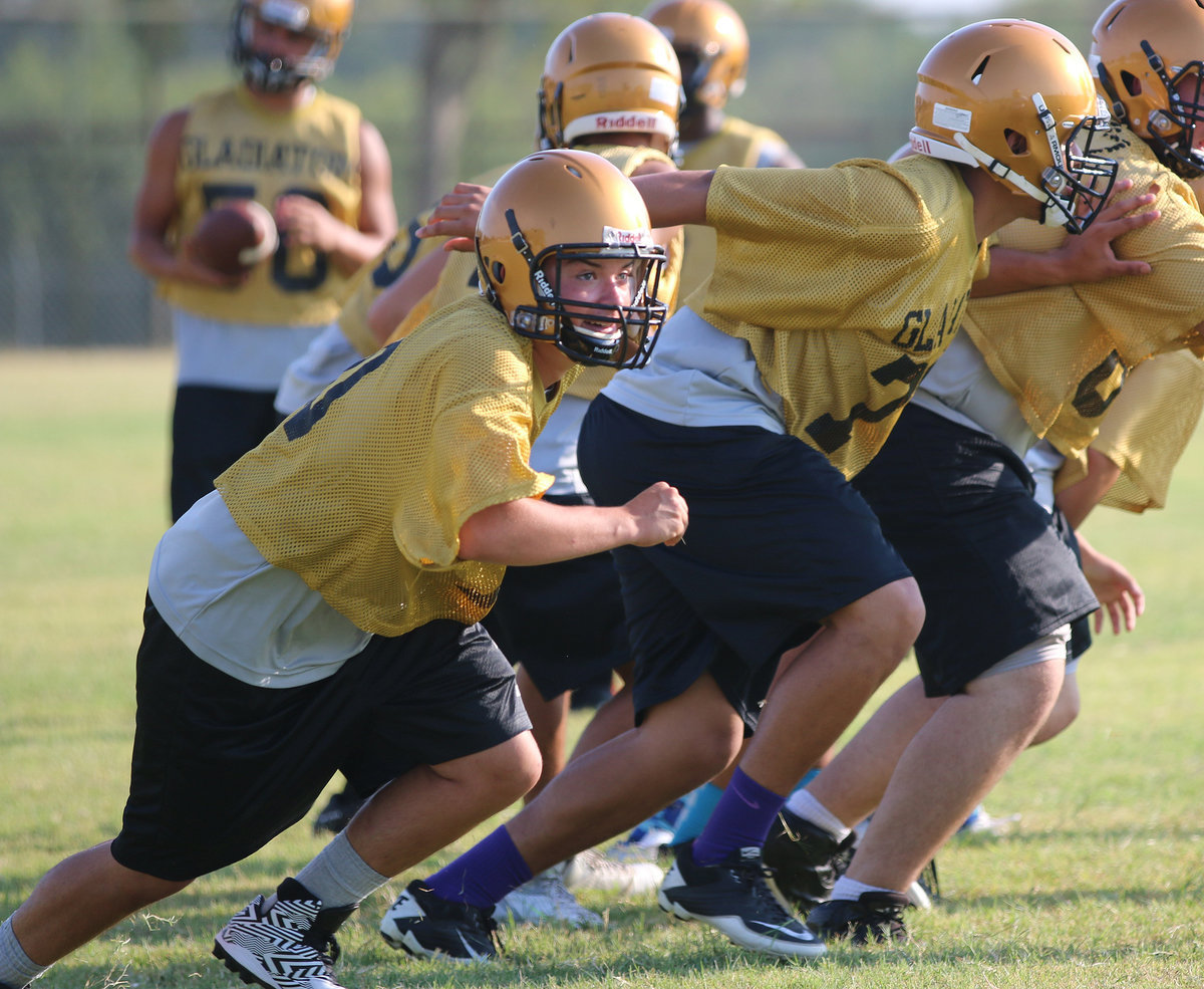 Image: Eli Garcia(70) and David De La Hoya(71) fire off the ball on offense.