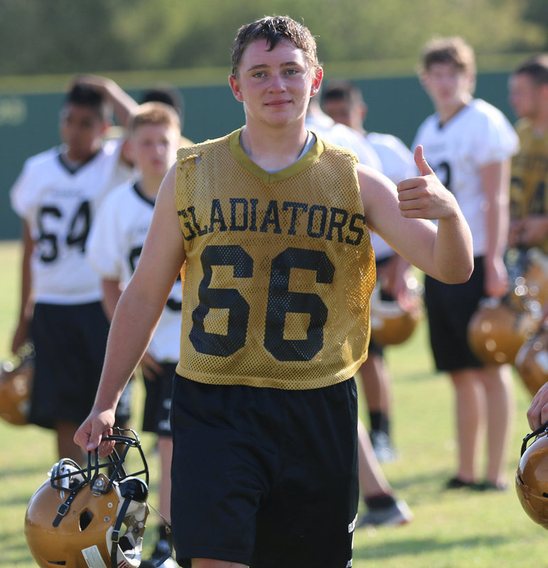 Image: Hunter Morgan(66) gives a thumbs up while wearing his dad’s, Brian Morgan’s (IHS 1988) old jersey number.