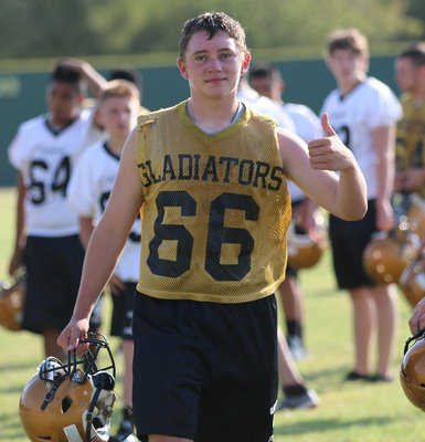 Image: Hunter Morgan(66) gives a thumbs up while wearing his dad’s, Brian Morgan’s (IHS 1988) old jersey number.