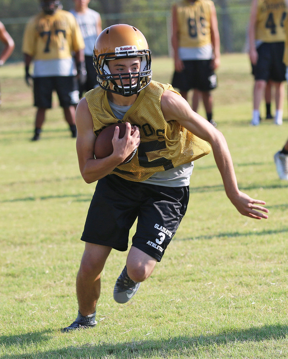 Image: Dyland McCasland(25) turns upfield after hauling in a pass.