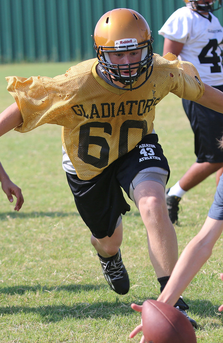 Image: Defensive tackle Clay Riddle(60) comes up with a fumble in the backfield during team drills.