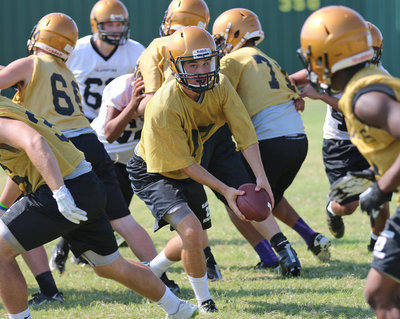 Image: Quarterback Ryan Connor(17) pitches the ball during team drills.