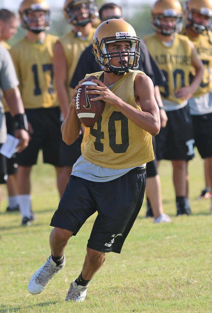 Image: Quarterback Tyland Wallace(40) executes a rollout pass.