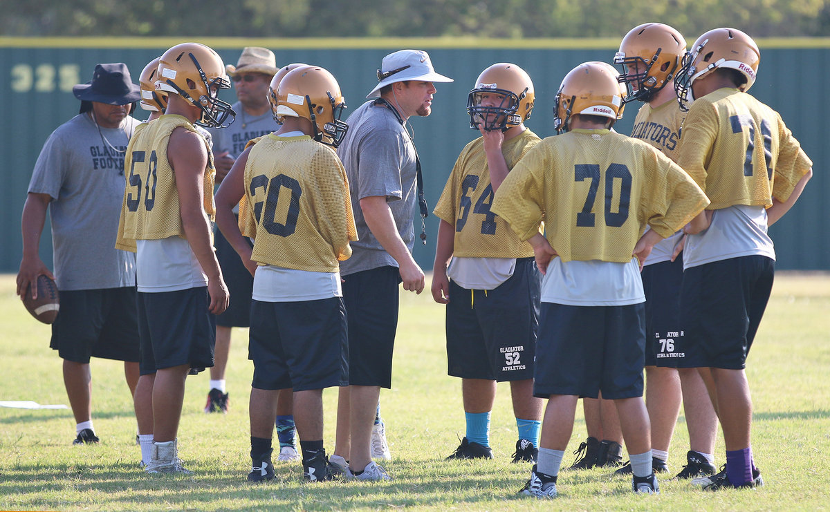 Image: First-year Italy Gladiator Football Athletic Director/Head Football Coach David Weaver addresses the offensive huddle during the first week of two-a-day practices.