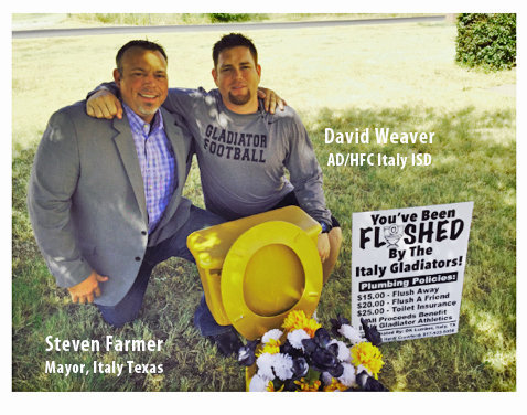 Image: City of Italy Mayor Steven Farmer is consoled by Italy ISD AD/HFC David Weaver after Mayor Farmer became the first recipient of a “Golden Potty” as part of a fundraiser sponsored by the Italy Gladiator Booster Club.