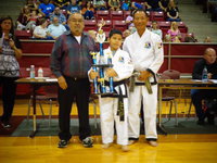 Image: Nick Sam, attends Italy ISD and has earned his first, 3 foot trophy after earning two 4 foot trophies in the past years.
Pictured is Master Charles Kight, chief instructor of the Hillsboro TKD school, Nick and Grand Master Park co-founder of Unified TKD.