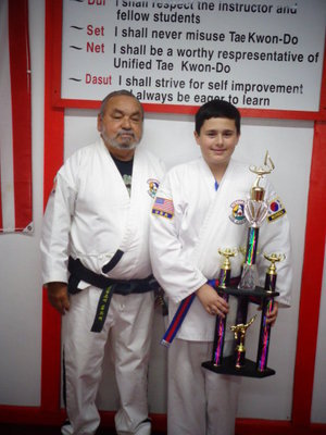 Image: Roger Ginnett attends Italy ISD and has earned his first 3 foot trophy after earning several other Academic trophies.
    Pictured is Master Charles Kight, chief instructor of the Hillsboro TKD school, Rocklin.