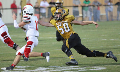 Image: Gladiator and sophomore Defensive tackle Clay Riddle(50) helps bring down a Maypearl running back.