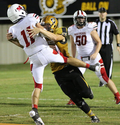 Image: Sophomore defensive tackle Clay Riddle(50) pressures Maypearl’s quarterback.