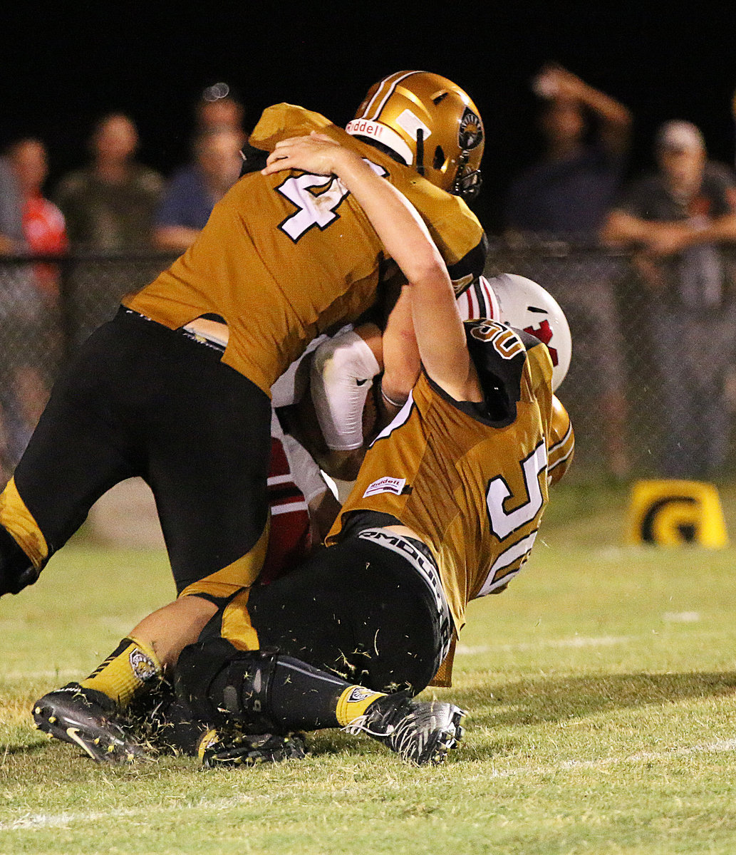 Image: Gladiator defenders Micah Escamilla(4) and Clay Riddle combine for a tackle in Maypearl’s backfield.