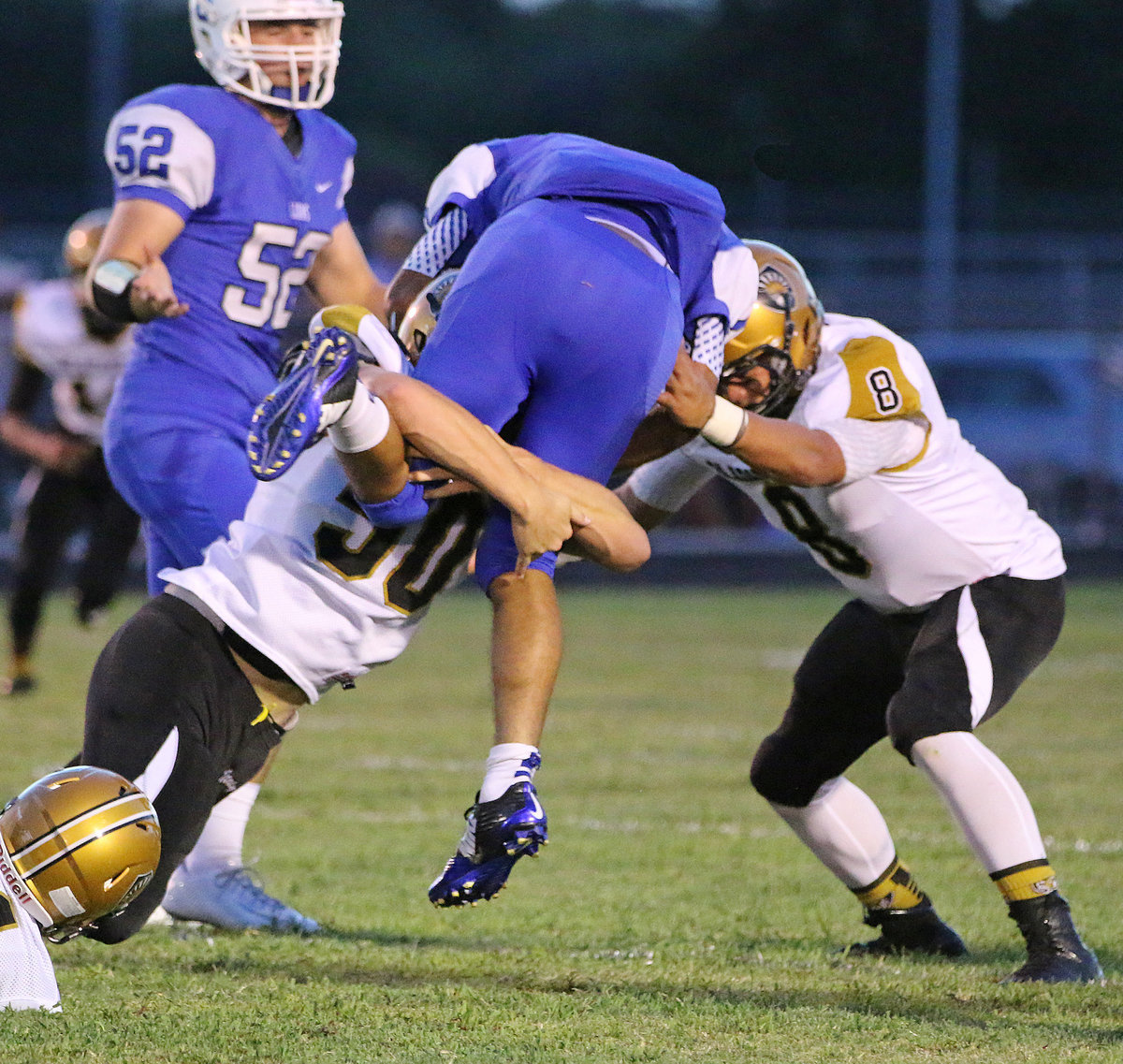 Image: Gladiator defenders Clay Riddle(50) and Joe Celis(8) put the hurt on a Lion running back.