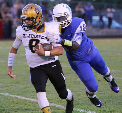 Image: Italy’s Joe Celis(8) tries to shake off a Blooming Grove tackler.