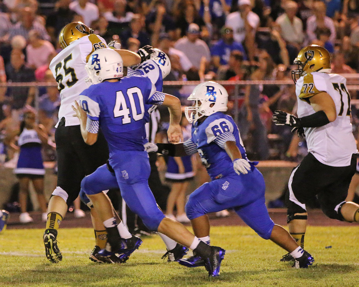 Image: Gladiator blocker Austin Pittmon(65) delivers a blow to the Lions as brother in arms Aaron Pittmon(72) hustles over to lend a hand.