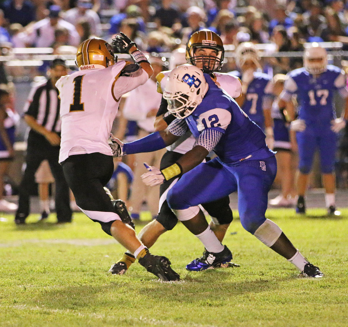 Image: Gladiator receiver Levi McBride(1) tries to work around a block thrown by his quarterback, Ryan Connor(7).