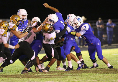 Image: Senior Gladiator Jaray Anderson(21) stops a Lion ball carrier in his tracks.