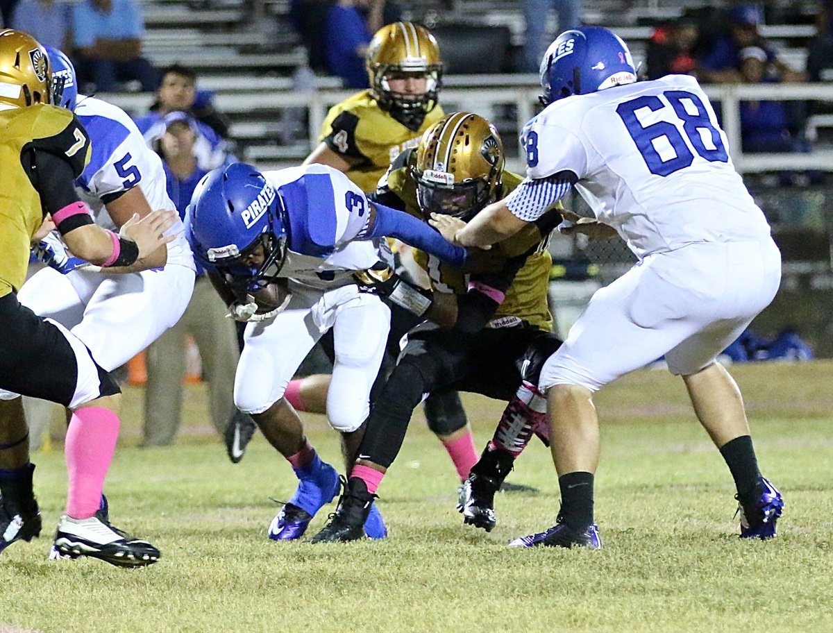 Image: Gladiator defender Fabian Cortez(11) beats the block to wrap up a Pirate runner from behind for no gain.