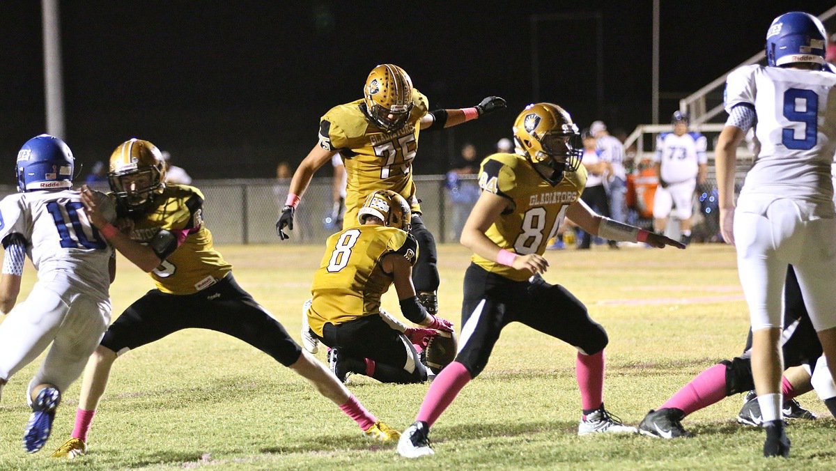 Image: David De La Hoya(75) boots thru the PAT with Joe Celis holding and with Clayton Miller(6) and Eli Garcia(84) blocking.