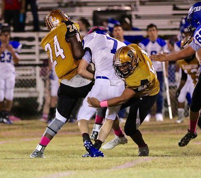 Image: Chistion Washington(24) lays the boom on a Pirate ball carrier with help from teammate Chris Davila(54). Defensively, Both Washington and Davila answered the bell against Chilton.