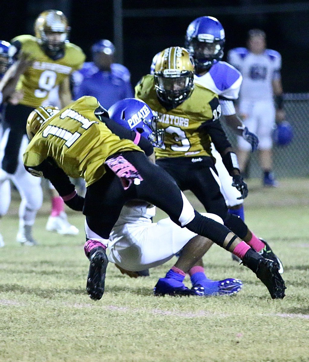 Image: Italy’s Fabian Cortez(11) sinks a Pirate ball carrier after this hard hit during a kickoff by the Gladiators.