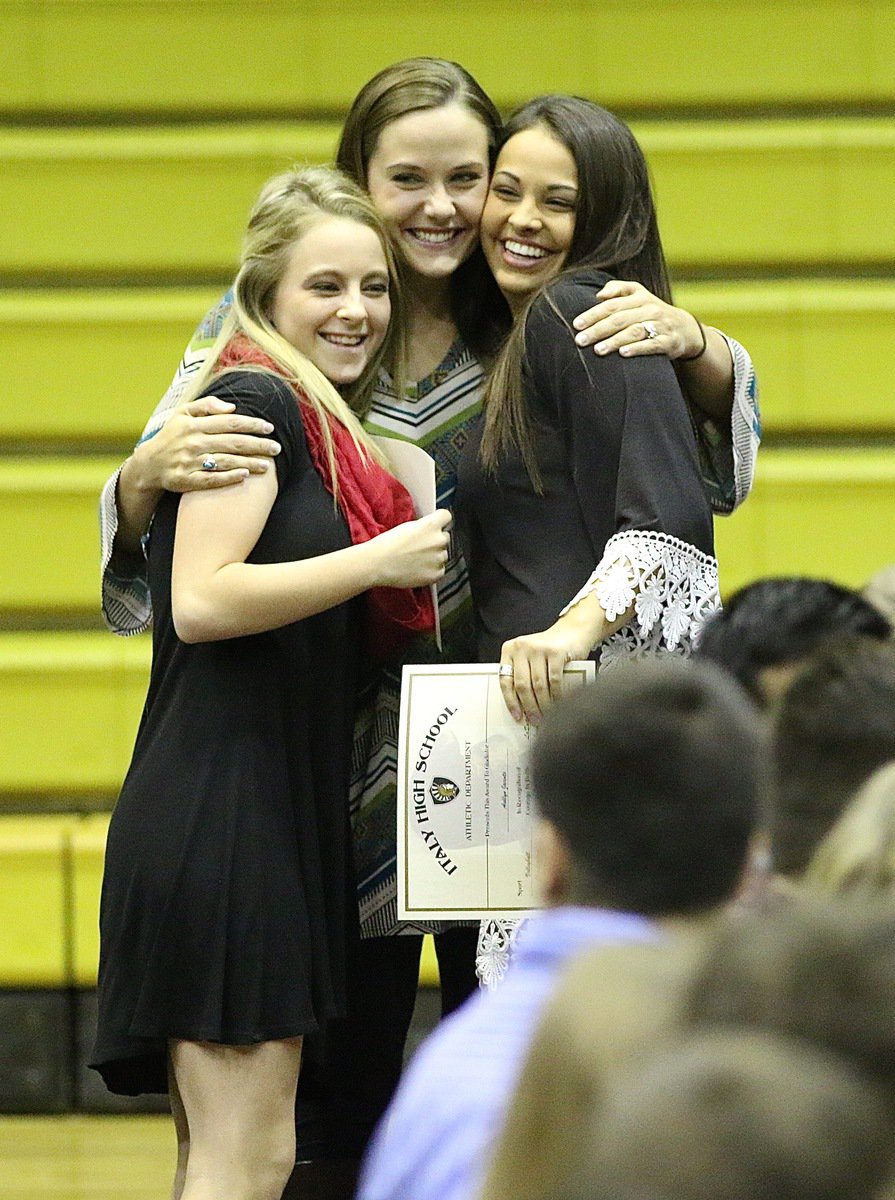 Image: Coach Holly Bradley hugs it out with Cross-Country teammates Britney Chambers and Ashlyn Jacinto.