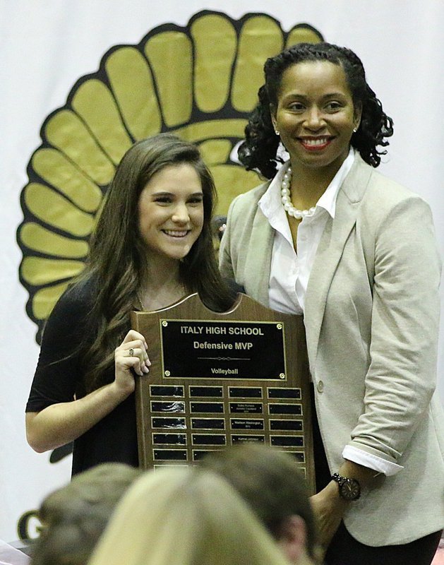 Image: Head Volleyball Coach Laquita Walker presents senior Cassidy Childers with the Italy Lady Gladiator Volleyball Defensive MVP Award.