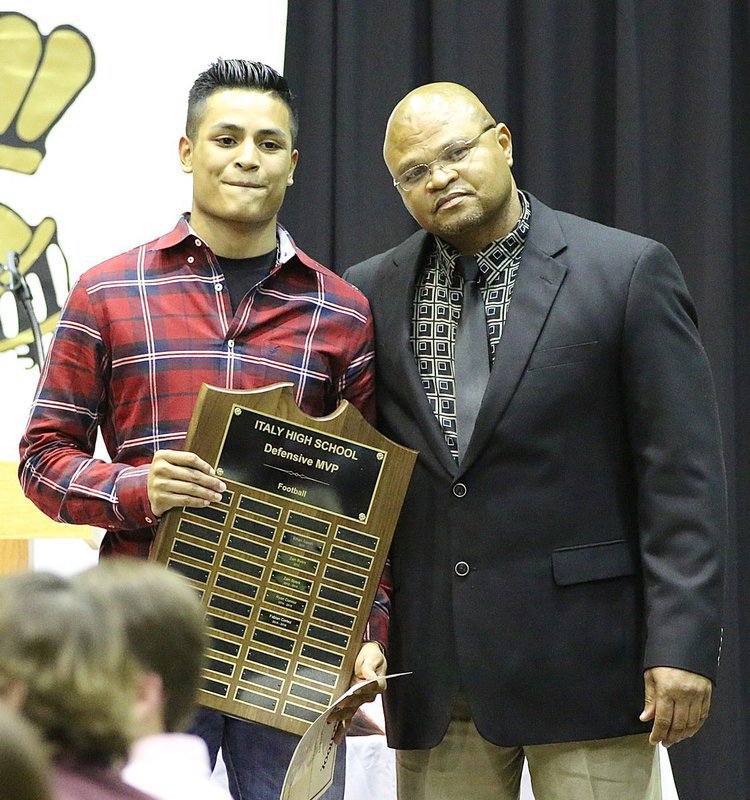 Image: Coach Bobby Campbell presents Fabian Cortez with the Italy Gladiator Football Defensive MVP Award.