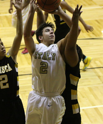 Image: Italy JV Gladiator Gary Escamilla(2) charges to the hoop and scores a basket against Itasca. Escamilla finished with 6-points.