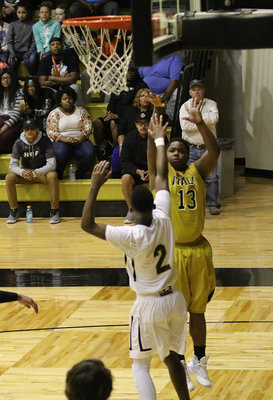 Image: Gladiator Kenneth Norwood(13) spots up on the baseline and swishes the bucket.