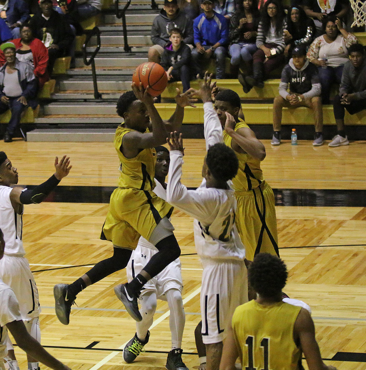 Image: Gladiator guard Kevin Johnson(5) shreds the Gator defense to put up a shot in the fourth.