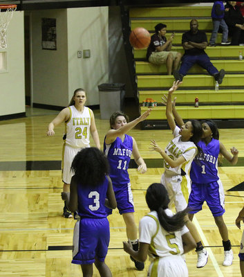 Image: Lady Gladiator Ta’Keya Pace(12) scores 2 of her 4-points against Milford.