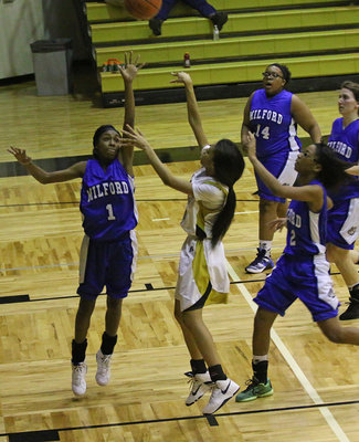 Image: Ta’Keya Pace(12) scores again for the Lady Gladiators despite a Milford defender between her and the hoop.